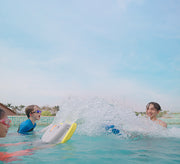 The 3 people are using the Asiwo Mako Electric Kickboards to play in the water.